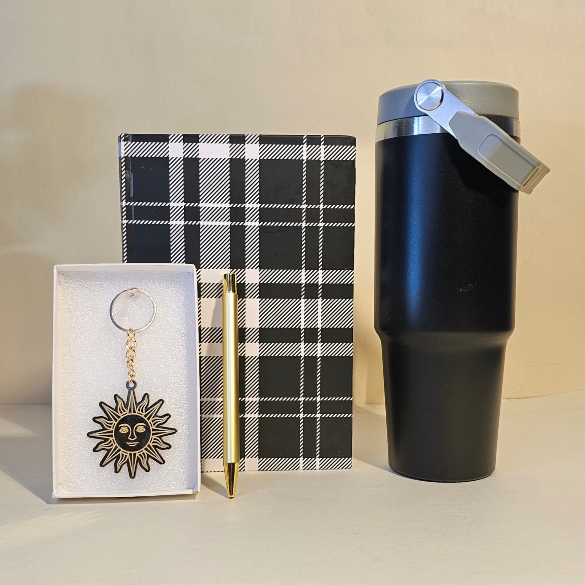 Black tumbler, plaid notebook, and keychain gift box