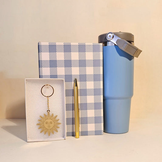 Blue tumbler, checkered notebook, and keychain gift hamper