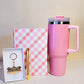 Pink tumbler, checkered notebook, and keychain gift hamper